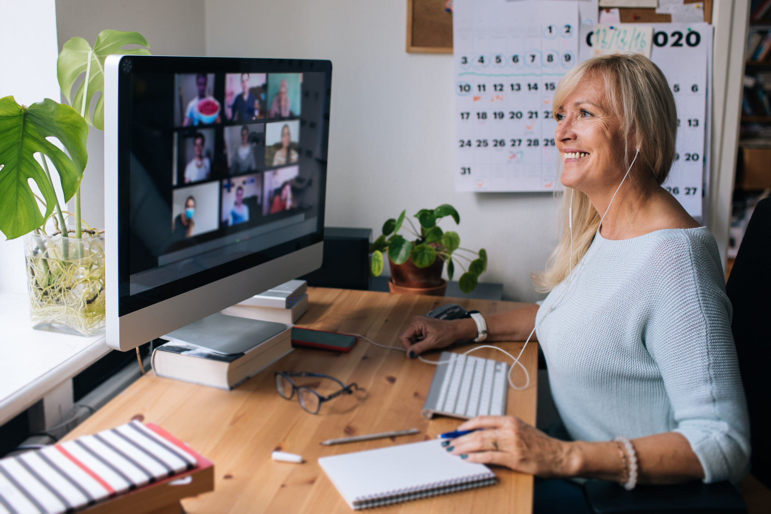 Image of woman sitting at desk with computer monitor showing online training